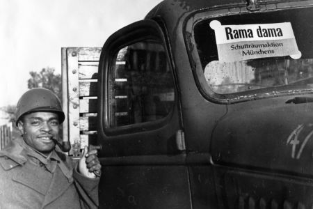 GI vor einem Auto mit dem Schild Rama dama